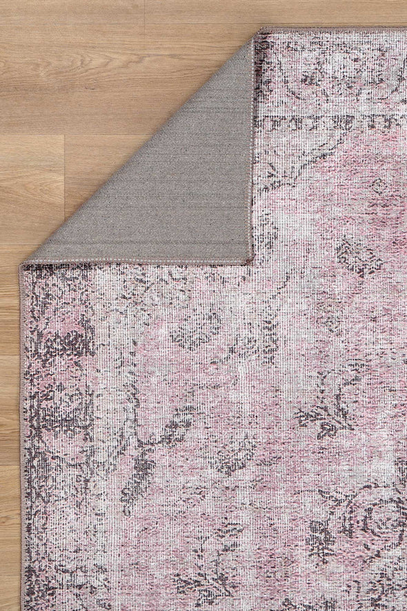 Indulge in the luxurious feel of the Germain Rose Rug. Its intricate medallion design and soft pink and brown hues add warmth and sophistication to any space. Plus, it's stain and water-resistant, so you can enjoy its beauty without worrying about spills.