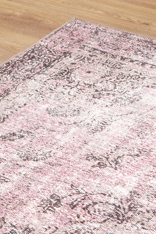 Experience luxury and practicality with the Germain Rose Rug. Its distressed medallion design adds sophistication to any space while its stain and water-resistant properties make it easy to clean. Plus, it's machine washable for added convenience.