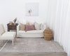 Agora Kasbah Ash Wool Rug in a living room with furnishings on blonde flooring