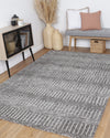 Alayah Geometric grey & ash Rug in living space with side board, wicker baskets on pink cushionsAlayah Geometric Charcoal & Beige Rug in sitting room with natural flooring, woven baskets , grey bench and pink cushions
