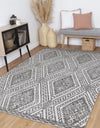 Alayah Zalij silver Rug on blonde flooring with grey seat and wooden accessories