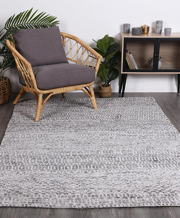 Alayah Camphils Silver Rug in living with green plants on dark flooring