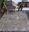 Alayah Charcoal Flower Rug in living space with grey chair on dark floors