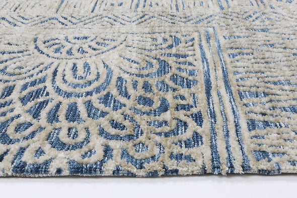 Alayah blue Flower Rug on white flooring side profile