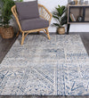 Alayah blue Flower Rug on dark timber flooring with wicker furniture and grey cusions