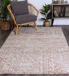 Alayah terracotta Flower Rug in living room with dark flooring and grey chair