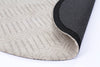 Alayah Geometric Ivory circle Rug folded over showing cotton backing