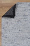 Allure Cotton Rayon Teal Rug folded corner on wooden flooring