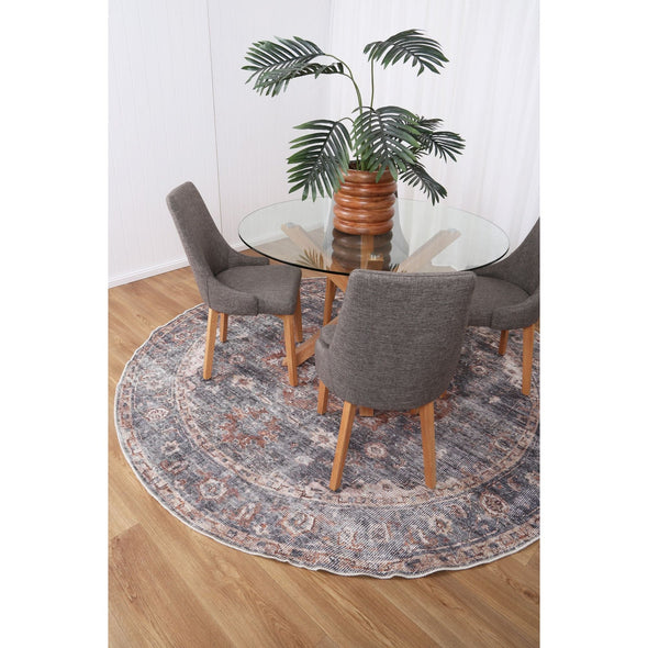 Practical and elegant round rug beneath a dining table, highlighting their stain and water-resistant capabilities thanks to NanoWipe technology